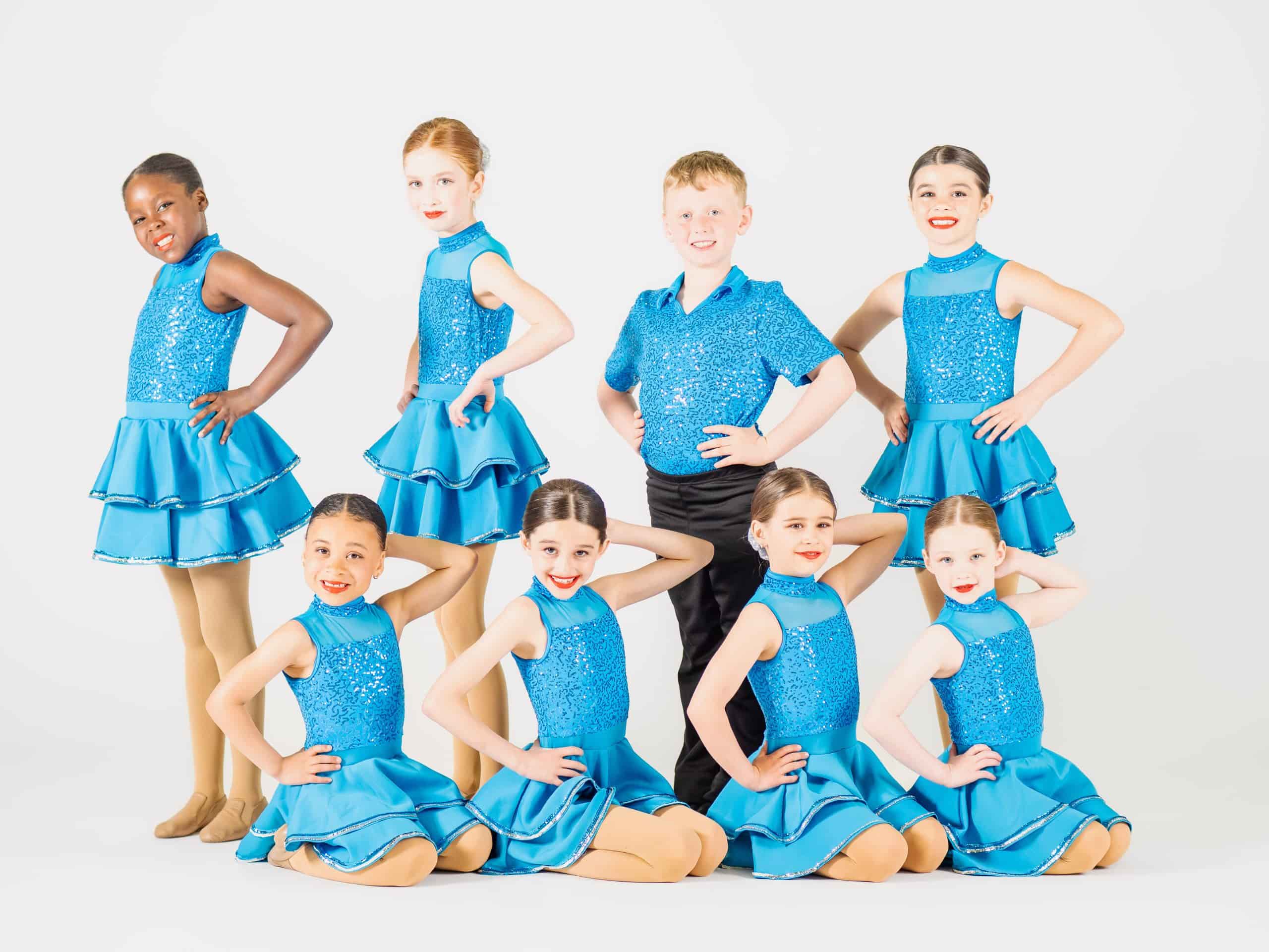 Group of students learning choreographed moves during a lively dancing class session